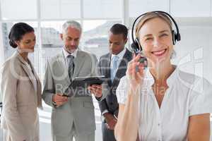 Smiling woman standing with a headset