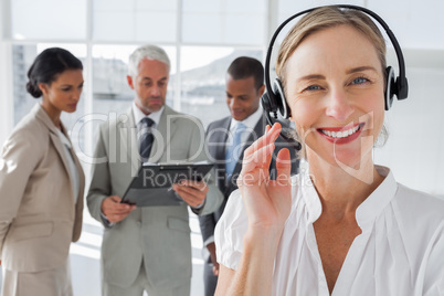 Close up of smiling woman standing with a headset