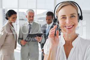 Close up of smiling woman standing with a headset