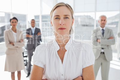 Serious businesswoman standing with arms folded