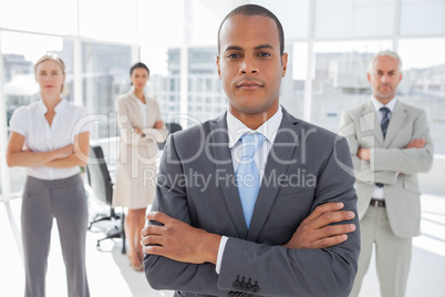 Serious businessman standing with arms crossed