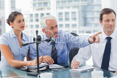 Business man pointing at something in a conference