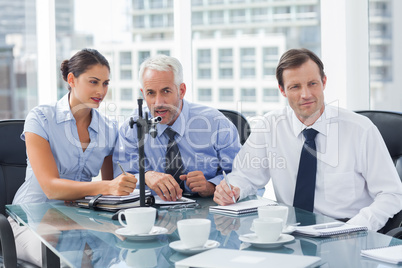 Businessman speaking in a microphone