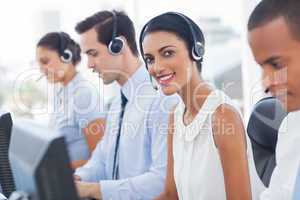 Smiling agent with colleagues sitting