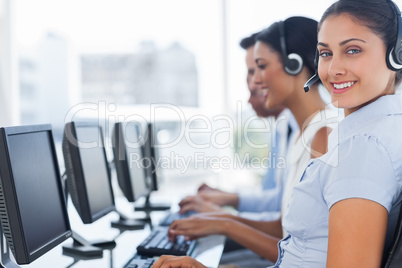 Smiling call center employee looking at camera