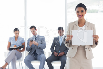 Smiling businesswoman holding a blank notice