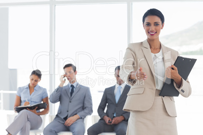 Smiling businesswoman giving a handshake