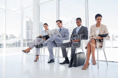 Well dressed business people sat together