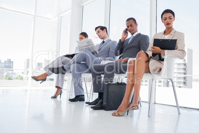 Business people working while waiting