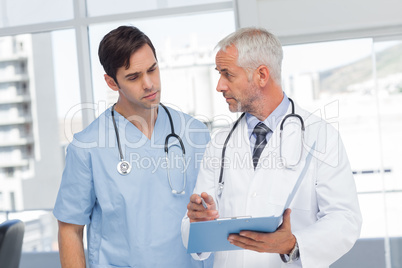 Doctors talking about a file