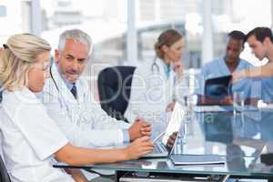 Two doctors using laptop