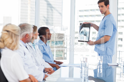 Doctor showing radiography to his team