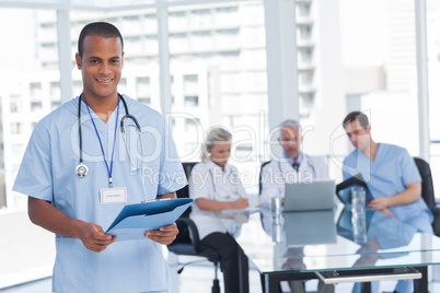 Smiling doctor holding file