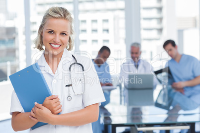 Smiling nurse holding file