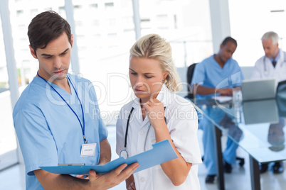 Two doctors examining a file