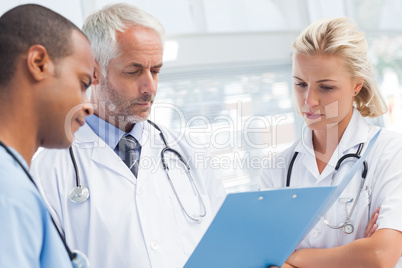 Doctors examining a file