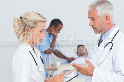 Doctors speaking together about the patient