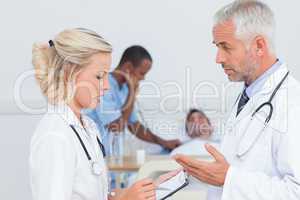 Doctors speaking together about the patient