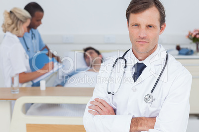 Serious doctor standing and looking at the camera