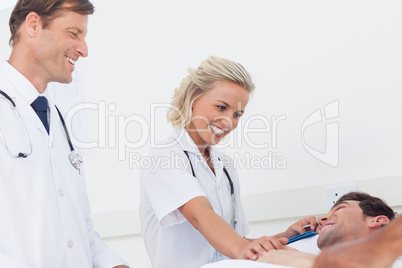 Smiling medical team taking care of a patient