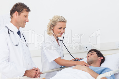 Doctor taking the heartbeat of her patient