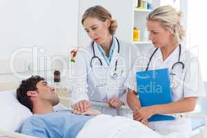 Two women doctors talking  to a patient