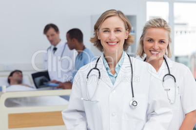 Two women doctors standing and looking at the camera