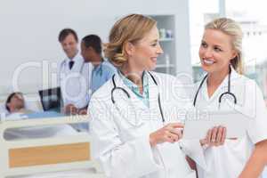 Smiling doctors talking to each other