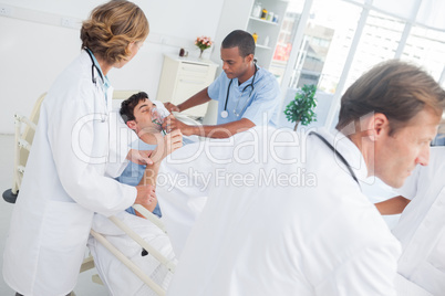 Doctors taking care of a sick patient