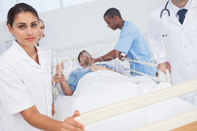 Nurse pushing bed of patient in emergency