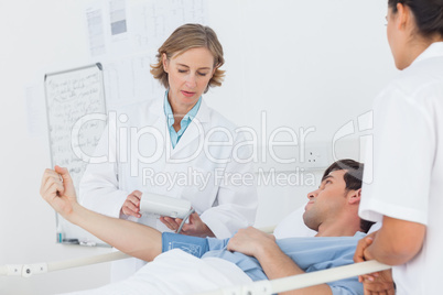 Doctor taking the blood pressure of male patient