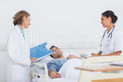 Doctors explaining the symptoms to a patient