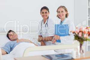 Patient and doctors looking at the camera