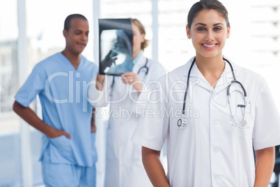 Woman doctor standing in a bright hospital