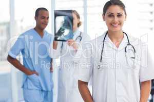 Woman doctor standing in a bright hospital