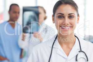 Smiling doctor standing in a bright hospital