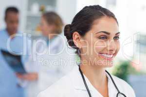 Smiling doctor standing in front of a medical team