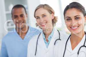 Three smiling doctors looking at the camera