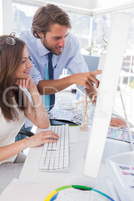 Creative team looking at computer