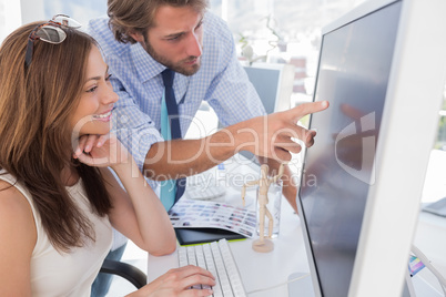 Man pointing something to his partner on screen