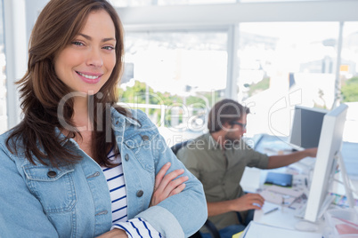 Woman smiling in creative office with arms folded