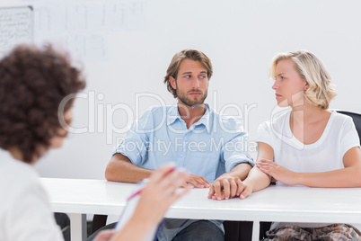 Couple looking doubtful during therapy session