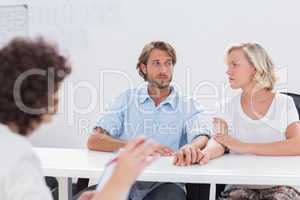 Couple looking doubtful during therapy session
