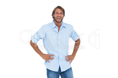 Laughing man with hands on hips
