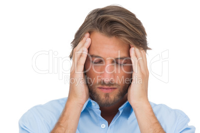 Handsome man touching his temples to calm a headache