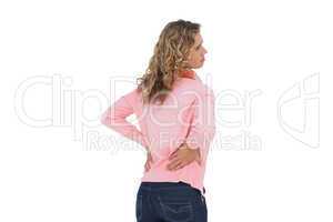 Woman having a back ache and holding her back
