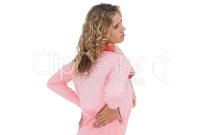Blonde girl having a back ache and holding her back
