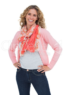 Smiling blonde woman posing with hands on hips