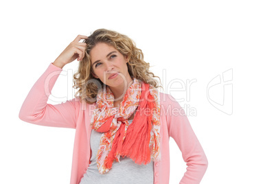 Attractive woman posing and smiling while scratching her head