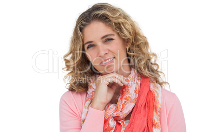 Smiling blonde woman posing with her hand on her chin